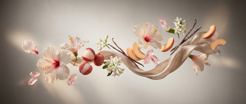  hibiscus petals, litchi flesh, soft white blossoms, peach slices, pink crystal shards, delicate vanilla sticks, and a flowing silky beige fabric ribbon.